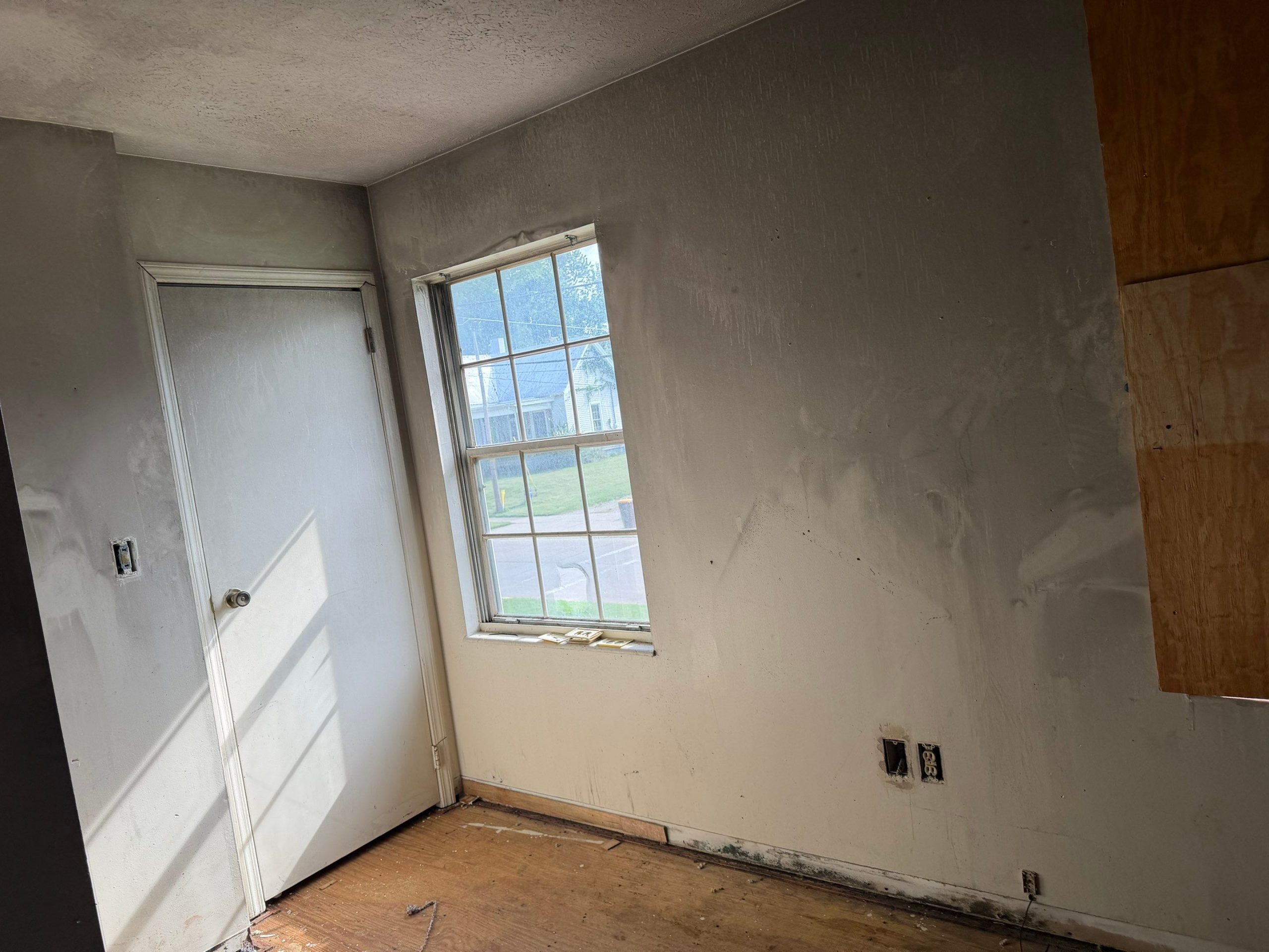 Room with soot-covered walls and ceiling following smoke damage