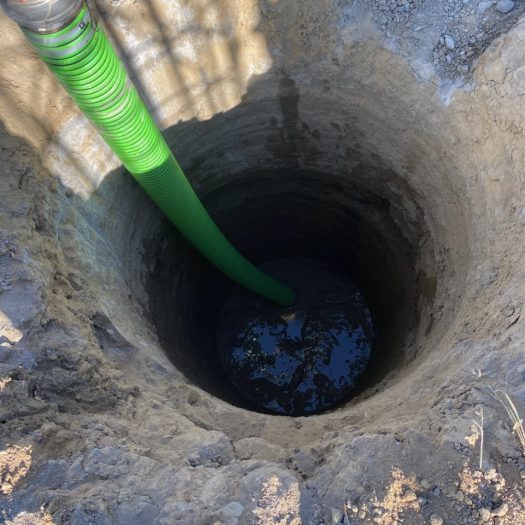 C2G vacuum truck removing muddy water from a ground excavation
