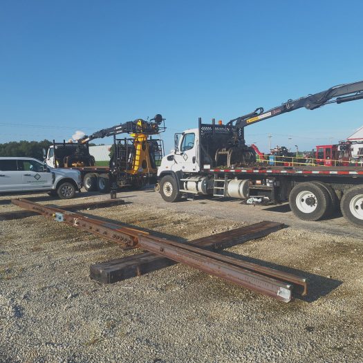 C2G grapple trucks with railroad rail and track materials