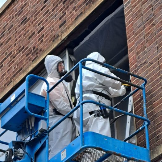 C2G Environmental technicians on lift performing asbestos abatement