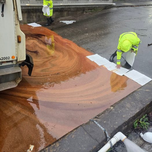 C2G technicians placing absorbent pads during diesel spill cleanup