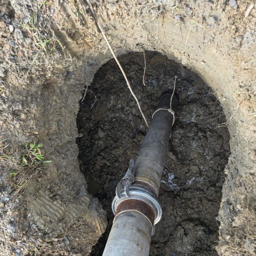 Suction pipe removing soil and water during C2G hydro-excavation